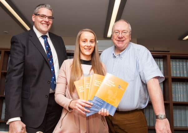 At the launch of the latest Journal of Orange history are (from left) Gavin Robinson MP, Rebecca Robinson, museum assistant, and Rev Mervyn Gibson, grand secretary of the Grand Orange Lodge