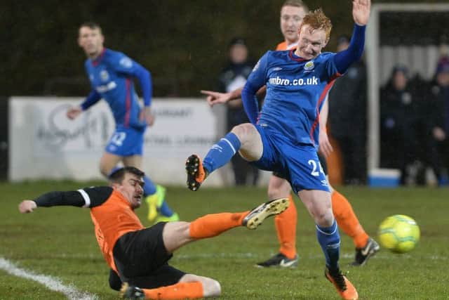 Linfield's Robert Garrett  and Carrick's Gavin Taggart  during Tuesday night's game at Taylor's Avenue