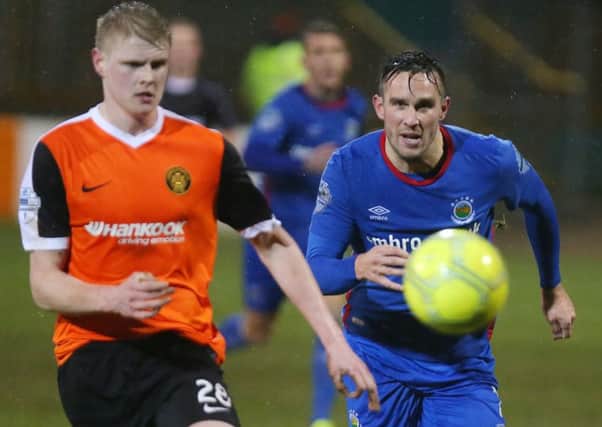 Carrick's Danny Magill with Linfield's Andrew Waterworth