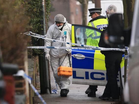 A forensics officer at the scene of an investigation at Matlock Road in Reddish on the outskirts of Manchester