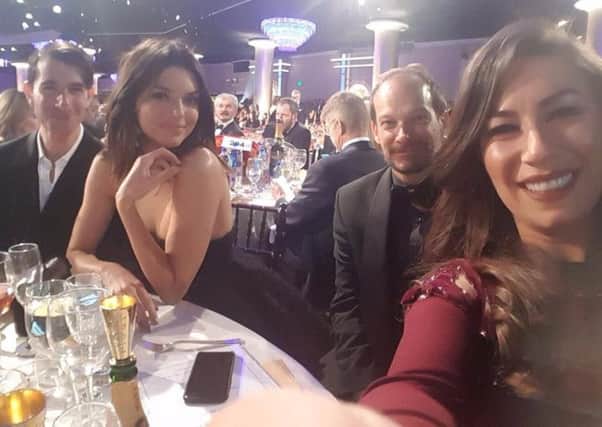 Rachel is pictured at her table with Kendall Jenner and style editor of vogue.com, Edward Barsamian