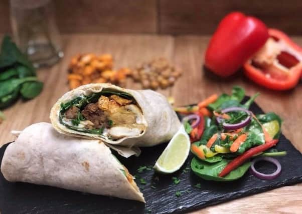 The all new breakfast wrap at The Honest Vegan, with chickpea scramble, home made sausage, spinach, new roast baked beans and sour cream with a side salad. Credit: The Honest Vegan: Facebook