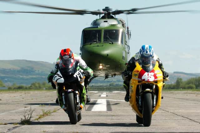 Ryan Farquhar (MSS Kawasaki) and Martin Finnegan (Vitrans Honda) try to outrun a British Army Lynx helicopter as they get in some speed testing ahead of the 2005 Junction One North West 200 at Ballykelly army base this week.
PICTURE BY STEPHEN DAVISON