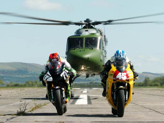 Ryan Farquhar (MSS Kawasaki) and Martin Finnegan (Vitrans Honda) try to outrun a British Army Lynx helicopter as they get in some speed testing ahead of the 2005 Junction One North West 200 at Ballykelly army base this week.
PICTURE BY STEPHEN DAVISON