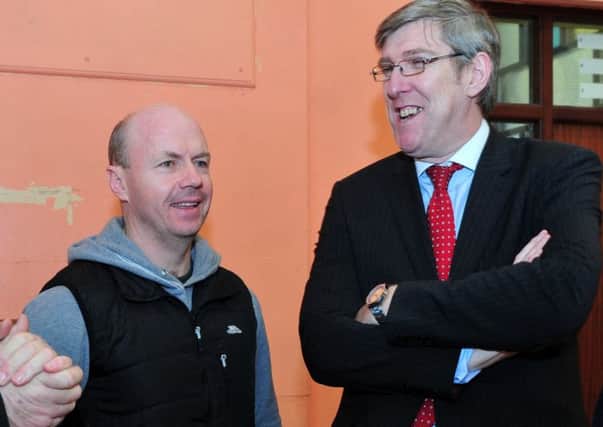 The then minister for education John O'Dowd (right) with Peter Canavan during his visit to Holy Trinity College, Cookstown in 2015