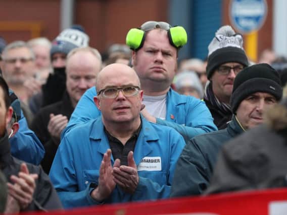 Bombardier workers in Belfast gather for a rally at the factory gates, as a union leader warns that thousands of workers will "flex their muscles" if a trade ruling goes against aircraft manufacturer