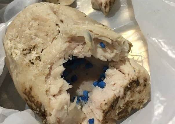 The chicken breast stuffed with blue pellets found by a dog owner.