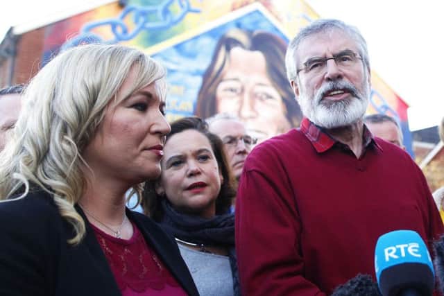 Mary Lou McDonald (centre) with Michelle O'Neill and Gerry Adams at the Bobby Sands mural on the Falls Road in Belfast