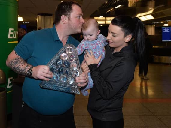 Masters snooker champion Mark Allen returns home to Northern Ireland with his wife Kyla and baby Harleigh