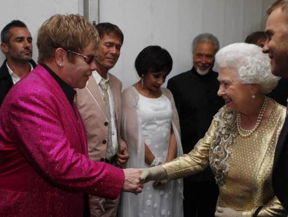 File photo dated 04/06/12 of Queen Elizabeth II meeting Sir Elton John backstage at The Diamond Jubilee Concert outside Buckingham Palace, London