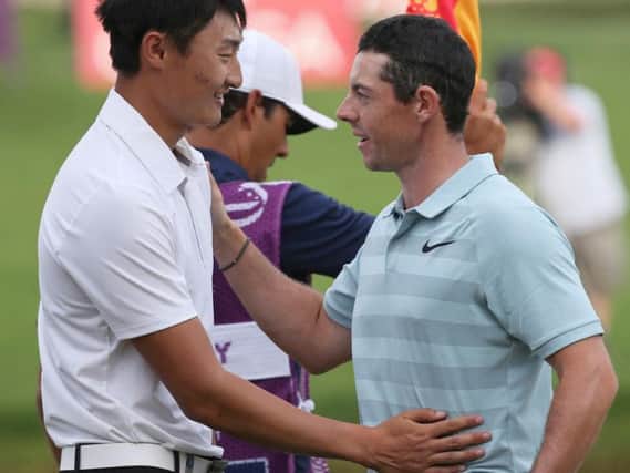 Northern Ireland's Rory McIlroy, right, congratulates China's Li Haotong, after he won the Dubai Desert Classic golf tournament in Dubai