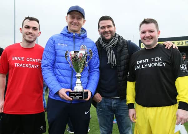 Nikki Coates and Sammy Clingan, the captain and manager of the Short Circuit team with David Healy and Gary Dunlop of the Road Racers team, who shared the trophy after a 1-1 draw in the Road Racers v Short Circuit racers charity football match at Seaview on Sunday.