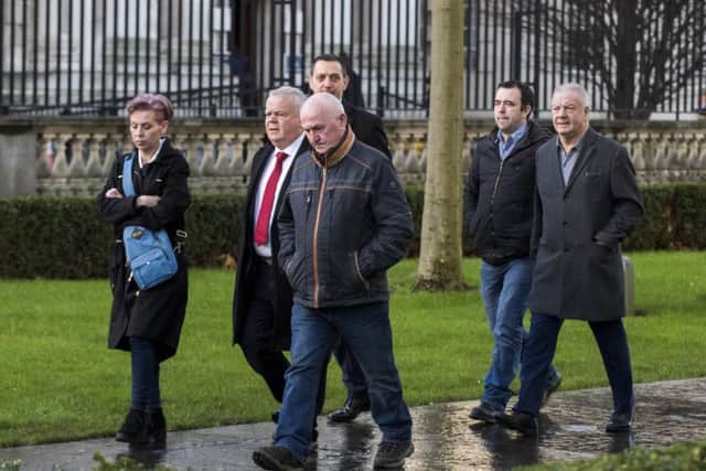 SDLP MLA John Dallat (2nd left), Joe Convie (father of Gary Convie, centre), solicitor Padraig O'Muirigh (centre back), Keiran Fox (son of Eamon Fox, 2nd right), and Raymond McCord Snr. (father of Raymond McCord Jnr. right) arriving at Laganside courts in Belfast for the sentencing of loyalist supergrass Gary Haggarty for a series of terrorism charges