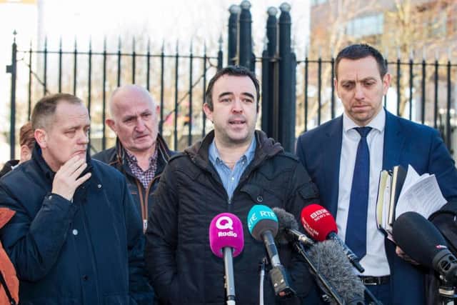 (Left to right) Aaron McCone (son of John Harbinson), Joe Convie (father of Gary Convie), look on as Keiran Fox (son of Eamon Fox) with solicitor Padraig O'Muirigh (right) speak to the media outside Laganside Court in Belfast