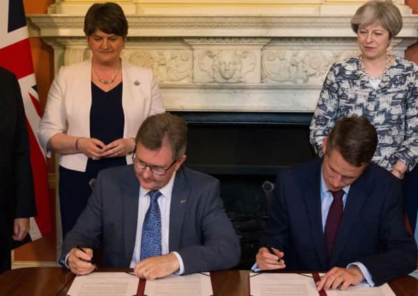 Prime Minister Theresa May with DUP leader Arlene Foster (left), as DUP MP Sir Jeffrey Donaldson (second right) and Chief Whip Gavin Williamson sign a deal to support the minority Tory government in 10 Downing Street in 2017. One of the DUP MPs, Sammy Wilson, says the party expects the government to quit the single market, the customs union and all jurisdiction of the European Court of Justice. Photo: Daniel Leal-Olivas/PA Wire