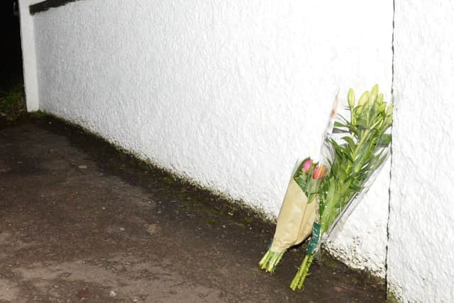 Flowers left at the Scene on Mill Road .
Photo Pacemaker Press