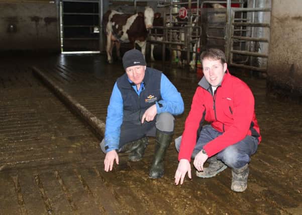 Moore Concrete's Jeff Haslett (right)  on- farm with Newtownstewart milk producer Trevor Wilson, inspecting the Surefoot"  slats that were specified for the new dairy unit.