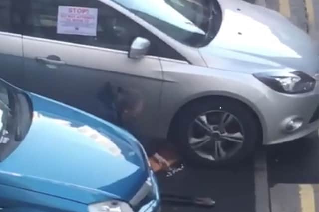 Screen grabs from social media showing Sinn Fein MLA Gerry Kelly removing a wheel clamp from his car parked in Belfast city centre on Friday morning.
 Photo: Pacemaker.