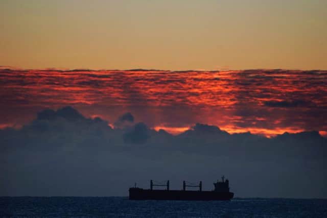 A Scarlett Manx Bulk Carrier sits in the North sea, near Whitley Bay as the sun rises