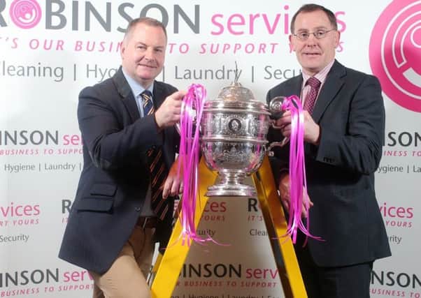 David Robinson (left), managing director of Robinson Services,  and Alan Waite, chairman of the Northern Cricket Union,  with the NCUs Premier League trophy which the  company will sponsor for the next three years.  The Antrim-based company  will also be putting its name to the Unions two Senior Leagues as well as awards throughout the season  for players who score a century, take at least six wickets or perform a hat trick.