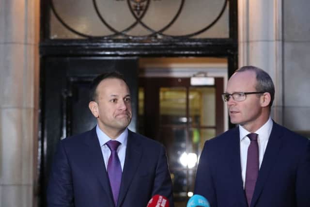 Taoiseach Leo Varadkar (left) and Irish Foreign Minister Simon Coveney speaking outside Stormont House in Belfast yesterday, following a bilateral meeting with Prime Minister Theresa May. The News Letter asked Mr Coveney whether Dublin still insisted on an Irish language act. Photo: Niall Carson/PA Wire