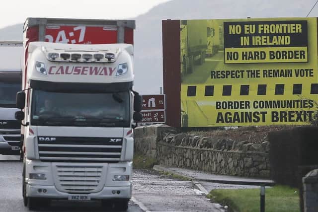 A truck passes a Brexit billboard in Jonesborough, Co. Armagh, on the northern side of the border between Northern Ireland and the Republic of Ireland. Photo by Niall Carson/PA Wire