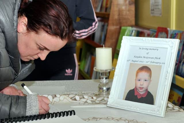 Natalie Coyle signs the book of condolences at Harryville Primary School