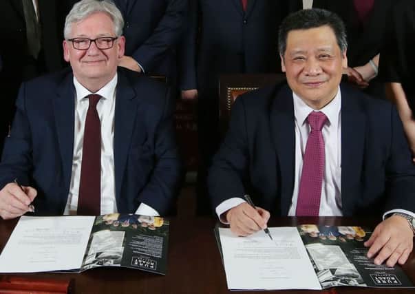 Martin Symington, managing director of Pure Roast Coffee in Lisburn, signing the joint venture agreement with William Wong of China Resources, Shenzen.