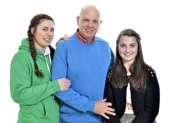 David Telford with daughters Emma, left, and Evie