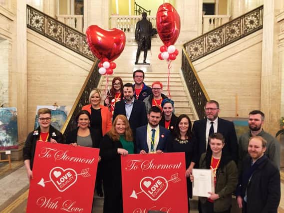 Same sex marriage campaigners and politicians at Stormont Parliament Buildings, where the teenage activists delivered Valentines Day cards, as talks to restore powersharing continue