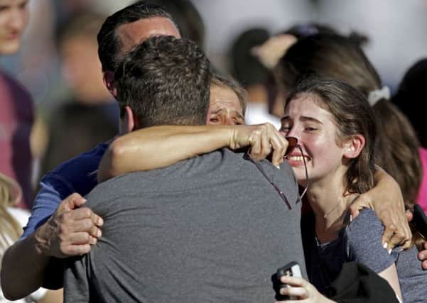 A family reunites following a mass shooting at Marjory Stoneman Douglas High School in Florida