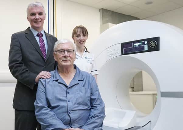 Cardiac patient Keith Miller with Dr Patrick Donnelly, consultant cardiologist, and radiographer Sarah Smythe with the new CT heart scanner