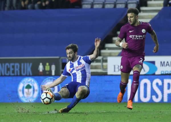 Wigan Athletic's Will Grigg scores the match winning goal which dumped Manchester City out of the FA Cup on Monday night