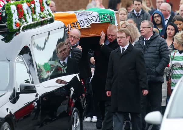 Mourners carry the coffin of Raymond Johnston at his funeral in Poleglass on Monday