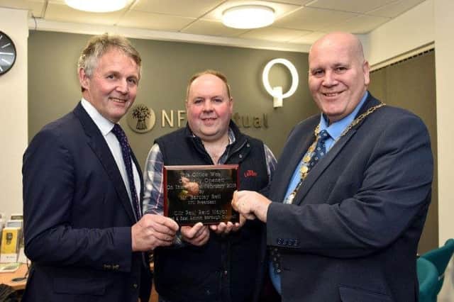 UFU President Barclay Bell and Mid & East Antrim Mayor Councillor Paul Reid present a plaque to UFU Larne Group chairman John Watt