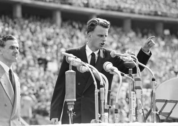 Evangelist Billy Graham speaks to over 100,000 Berliners at the Olympic Stadium in Berlin, Germany in 1954.  (AP Photo, File)