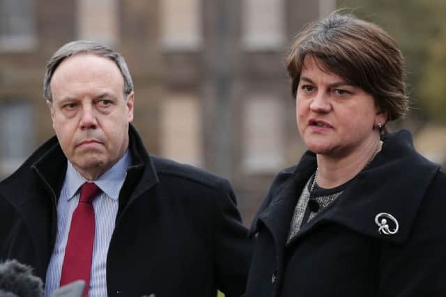 DUP leader Arlene Foster and deputy leader Nigel Dodds speaking to the media on College Green in Westminster yesterday