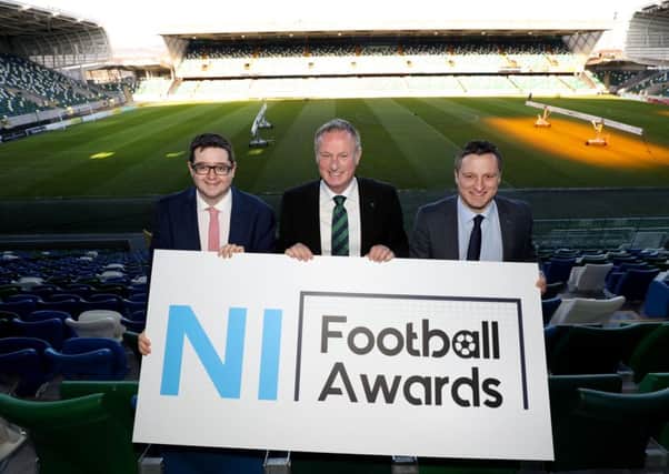 NIFWA Chair Keith Bailie, Northern Ireland manager Michael O'Neill and NIFL Managing Director Andrew Johnston with the new NI Football Awards logo.