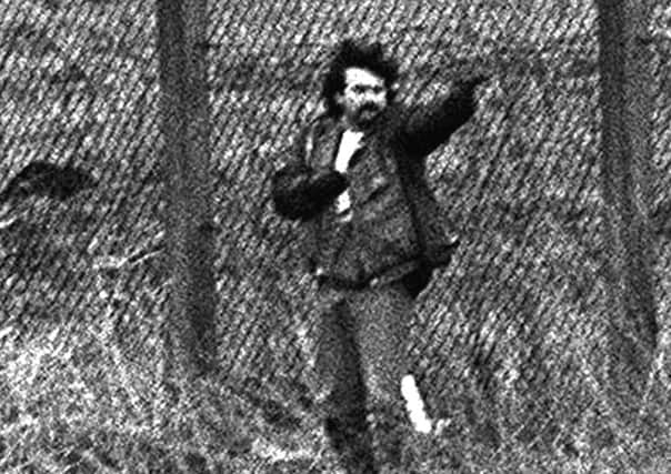 Loyalist gunman Michael Stone attacks mourners at an IRA funeral in Milltown cemetery