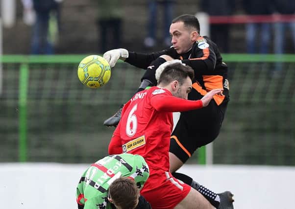 Cliftonville goalkeeper Brian Neeson punches the ball clear against Glentoran