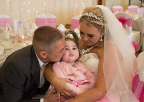 Mark and Jamie Pollock with their daughter Lacey, aged four, who has now sadly passed away due to a mystery condition