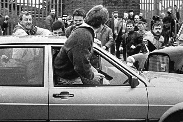 PACEMAKER BELFAST: Corporal Derek Wood attempts to escape the crowd at the funeral of IRA man Kevin Brady in March 1988.