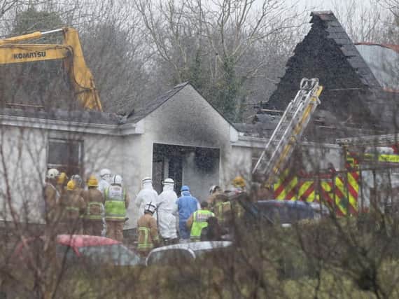 Forensic and fire officers at a house in Derrylin, Fermanagh where three people have died in a fire and police have arrested a man at the scene on suspicion of murder