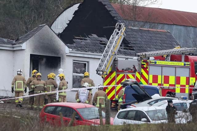 Forensic and fire officers at a house in Derrylin, Fermanagh where three people have died in a fire and police have arrested a man at the scene on suspicion of murder