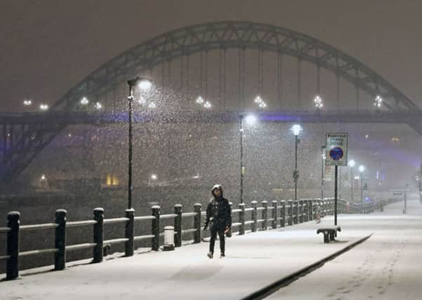 A person walks through Newcastle Quayside following heavy overnight snowfall which has caused disruption across Britain. PRESS ASSOCIATION Photo. Picture date: Tuesday February 27, 2018.