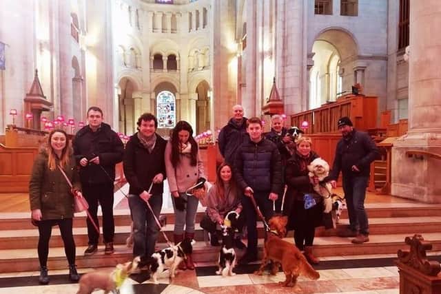 Only well practiced dog tour leader, Georgie, is posing for the camera in our group photo in the cathedral