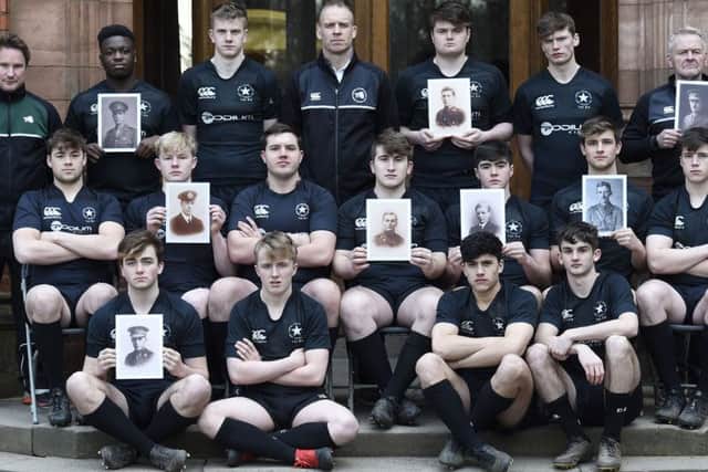 The First XV rugby team at Campbell College Belfast poses with portraits of their counterparts who died in WWI