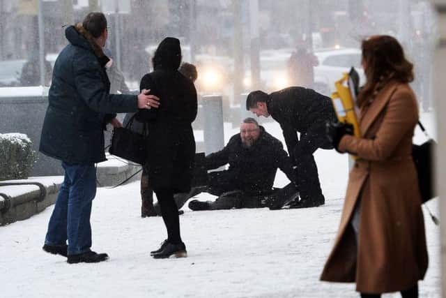 A man is uninjured after slipping during  the wintery weather in Belfast city centre on Thursday