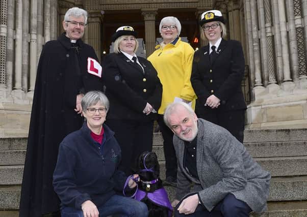 Comedian Tim McGarry (front right) and Very Rev Stephen Forde (back left) with charity representatives at St Annes Cathedral