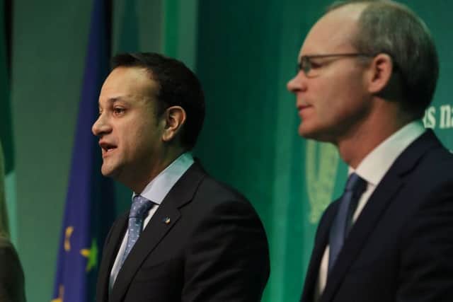 Taoiseach Leo Varadkar (centre) and Tanaiste Simon Coveney (right) in Dublin after the European Commission announced that "sufficient progress" has been made in the first phase of Brexit talks in December. Photo: Brian Lawless/PA Wire